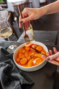 Cropped hand of person preparing food on table