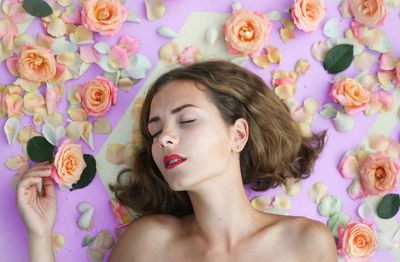 Young woman surrounded by flowers