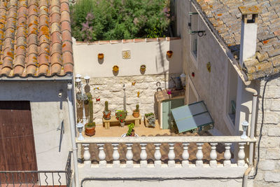 High angle view of potted plants on balcony of building