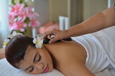 Low angle view of woman lying down on hand