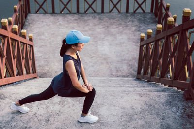 Sportwoman exercise stretching on stairs outdoor healthy lifestyle.