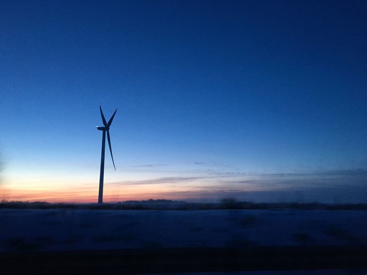 SILHOUETTE OF WIND TURBINE AGAINST SKY DURING SUNSET