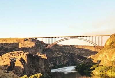 Bridge over river against clear sky