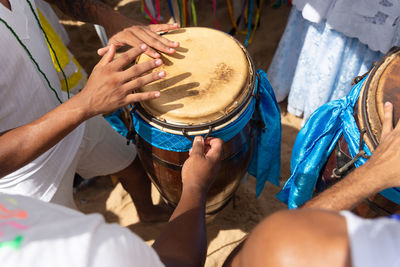 Percussionist hands playing atabaque.