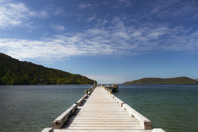 Pier over lake against sky