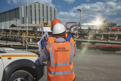 Rear view of man working at bus