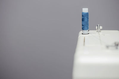 Close-up of electric lamp on table against white background