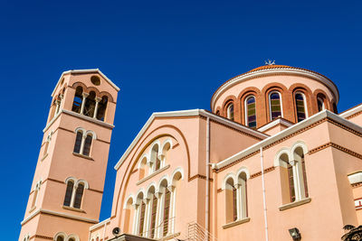 Low angle view of building against clear blue sky