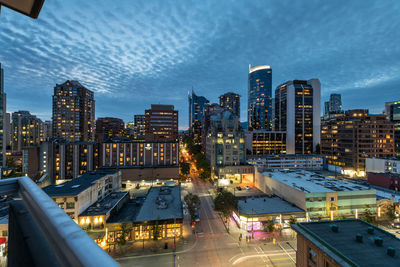 High angle view of illuminated buildings against sky at dusk