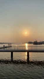 Silhouette pier on sea against sky during sunset