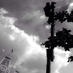 Low angle view of street light against cloudy sky