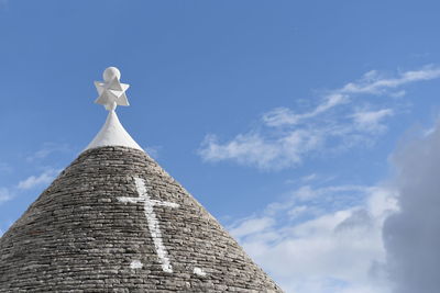 Low angle view of a trullo house against sky