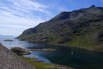 Scenic view of lake and mountains against sky