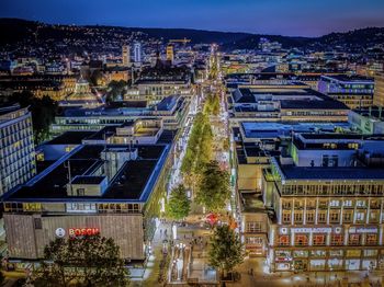 Aerial view of city lit up at night