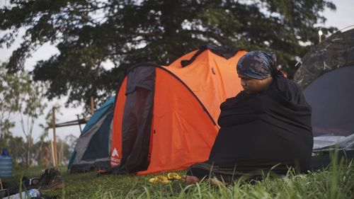 Tent on field against trees