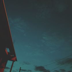 Low angle view of silhouette building against sky at night