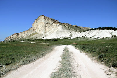 Empty road leading towards natural landmark in crimea