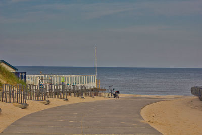 People at beach against sky