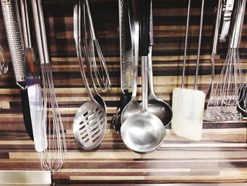 Close-up of kitchen utensils hanging on wall