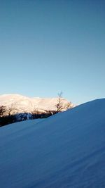 Scenic view of snow covered mountain against clear sky