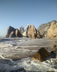 Scenic view of rock formations on beach