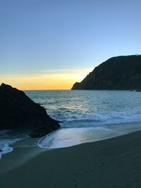 Scenic view of sea against clear sky during sunset