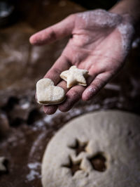 Cropped hands making cookies at table