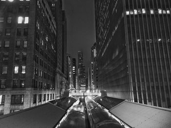 Low angle view of tall buildings at night