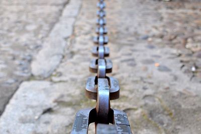 Close-up of padlocks hanging on metal