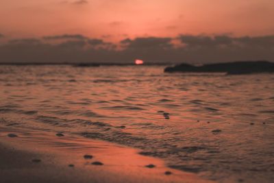 Scenic view of sea against sky at sunset