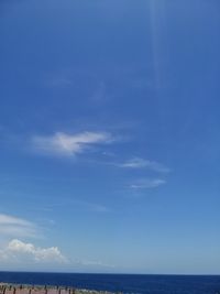 Scenic view of sea against blue sky