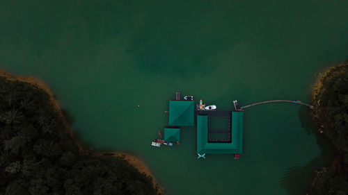 High angle view of illuminated lights by sea