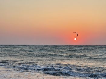 Scenic view of sea against orange sky