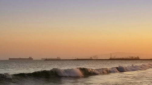 Scenic view of sea against clear sky during sunset