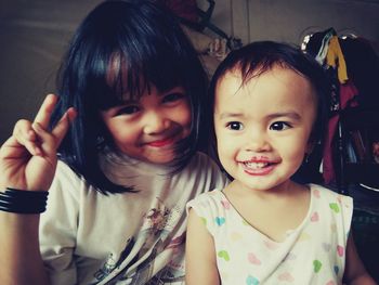 Portrait of cute smiling siblings indoors