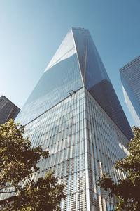 Low angle view of one world trade center against blue sky