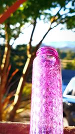 Close-up of ice cream cone against trees