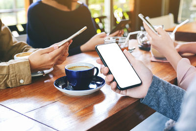 People having coffee at cafe table