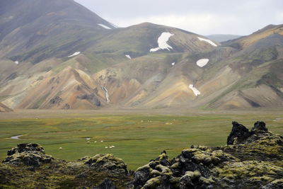 Scenic view of volcanic landscape and mountains against sky