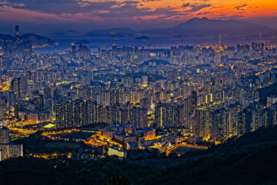 High angle view of city lit up at dusk