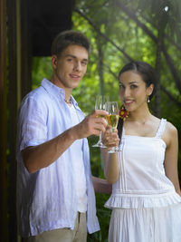 Portrait of smiling couple toasting wines