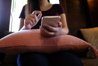 Midsection of man using mobile phone