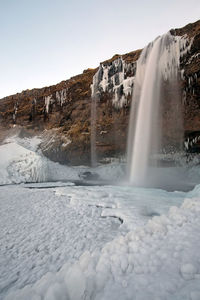 View of waterfall against rocks