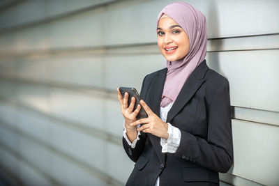 Mid adult woman using mobile phone