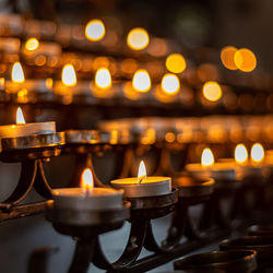 Illuminated tea light candles in church