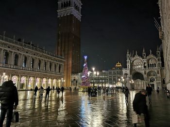 Group of people in front of building at night