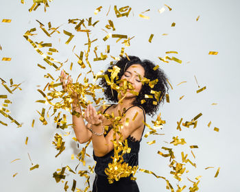 Portrait of happy woman in confetti