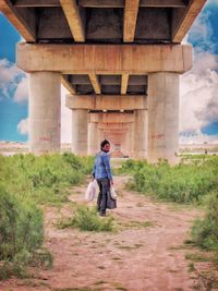 Rear view of woman walking on road