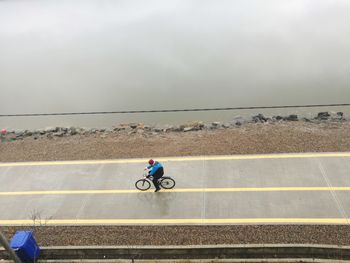 High angle view of man riding bicycle on road