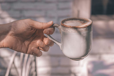 Close-up of hand holding drink coffee